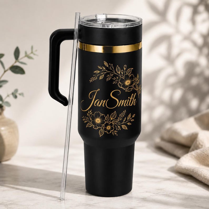 Black 40oz tumbler with personalised floral name gold engraving